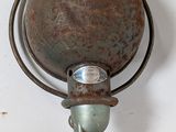 a rusted metal object hanging on the wall