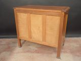 a small wooden cabinet with a door on it
