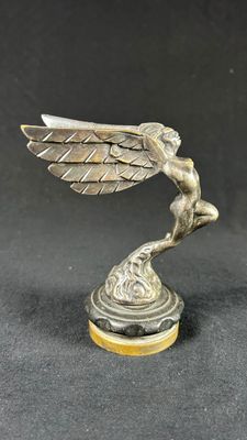 an image of a statue of a winged bird on a pedestal