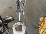 a machine that is sitting on the floor next to a chair