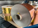 several rolls of aluminum foil are stacked on a shelf in a warehouse