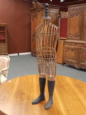 a wooden mannequin on a table in the middle of a room