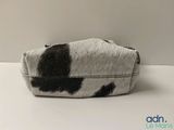 an image of a cow print purse on a table