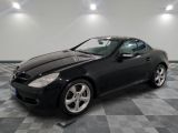a picture of a black mercedes slk parked in a garage