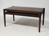 a wooden coffee table with a drawer underneath it