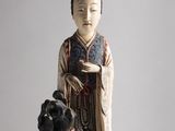 statue of a woman holding a pot and a dog