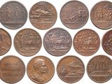 a close up of a bunch of coins on a white surface