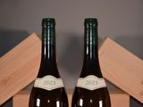 two bottles of wine that are sitting on a table