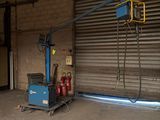 a blue crane that is sitting in a garage