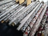 many rolls of wallpaper on a table in a room