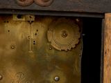 a clock that is sitting on a wooden table