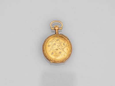 a gold pocket watch with a roman coin on the front