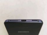 a close up of the back of a black samsung phone