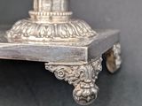 a silver vase sitting on top of a table