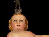 a statue of an angel with a crown on it ' s head