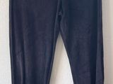 un gros plan sur un pantalon noir accroché au mur