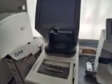a computer sitting on top of a desk next to a printer