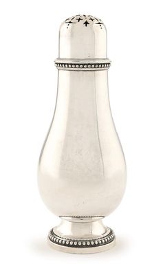 an antique silver salt shaker on a white background