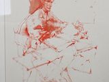 a red drawing of a man sitting on a chair