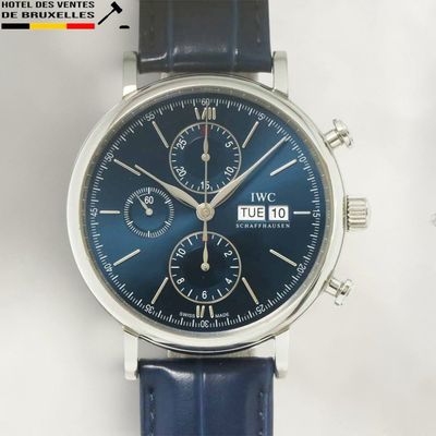 a close up of a wrist watch with a blue dial