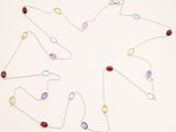 silver chain with multi - colored stones on a white background