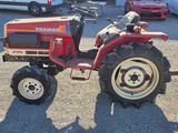 a red tractor that is parked in a parking lot