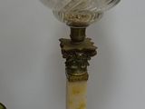 a lamp that is sitting on a table next to a clock