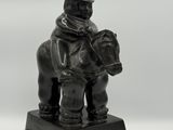an image of a statue of a man riding on a horse