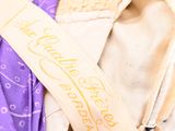 a close up of a purple and white tie on a mannequin ' s head