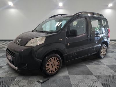 a picture of a small black van parked in a garage