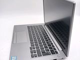 a silver laptop computer sitting on top of a white table