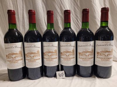 six bottles of wine are lined up on a table
