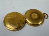 gold plated pocket watch with sunburst design and chain