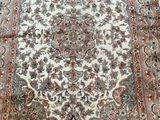 an antique persian rug is on the floor in a room