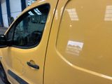 a yellow van that is parked in a garage