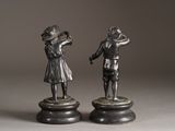 pair of antique bronze figurines of a boy and a girl