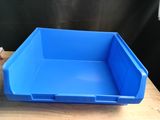 a blue plastic bin sitting on top of a wooden table