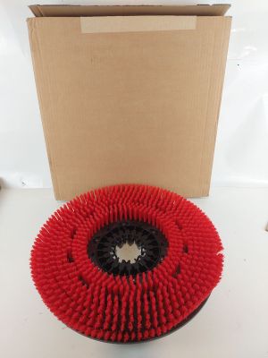 a close up of a red brush on a white surface next to a cardboard box