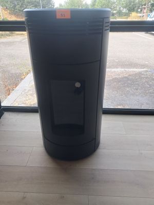 a black trash can sitting in front of a window