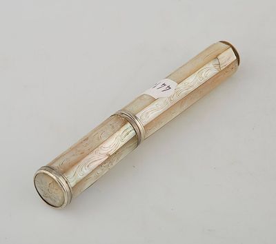an old silver and gold telescope on a white surface