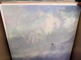 a picture of a painting in a box with a person holding it