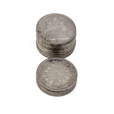 several coins are stacked on top of each other on a white surface