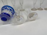 several empty wine glasses are lined up on a white surface