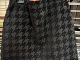 a black and grey houndsered skirt hanging on a rack