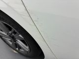a close up of a car ' s tire on the side of the road