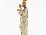 a statue of a woman holding a child and wearing a crown