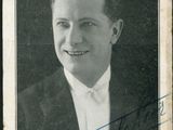 a black and white photo of a man in a suit and tie
