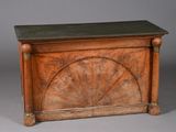 an old wooden chest with a fan design on the top of it