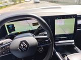 the interior of a car with a steering wheel, dashboard, and a gps device