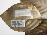 a close up of a gold leaf with a label on it